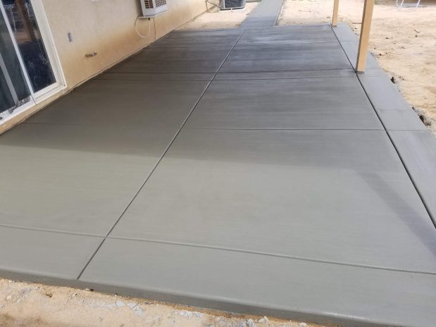 A concrete patio with neatly arranged concrete pavers