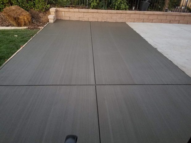 A concrete patio with neatly arranged concrete pavers.