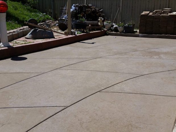 Concrete patio with a red fire hydrant and a yellow fire hydrant.