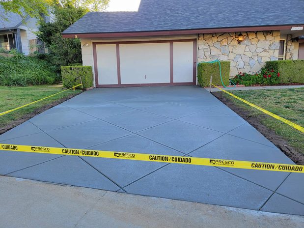 A driveway with caution tape around it.