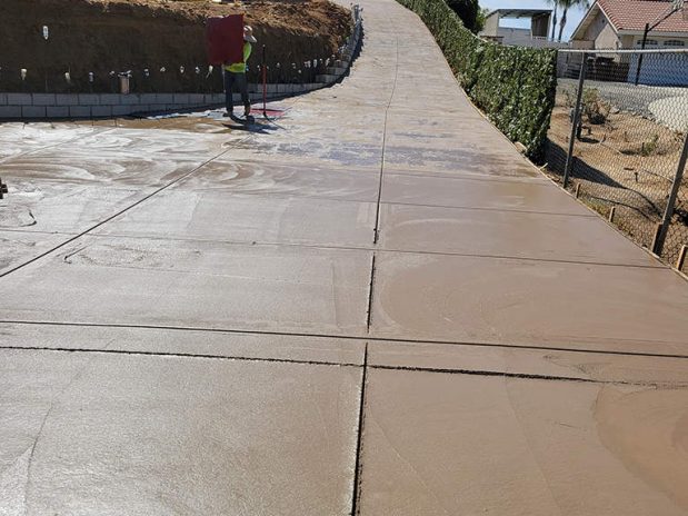Man walking on concrete driveway.