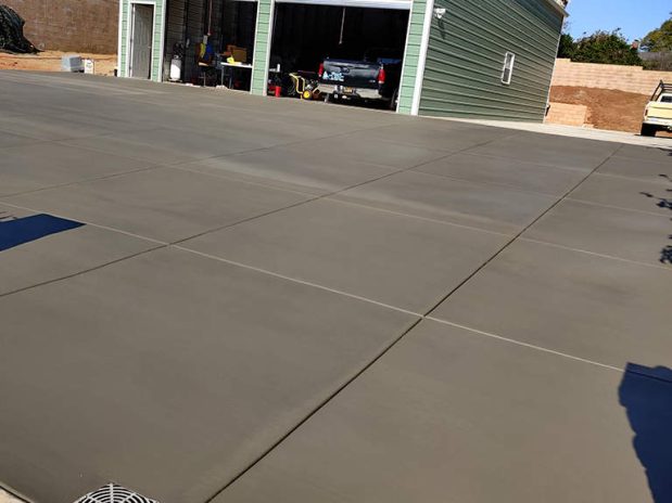 A concrete driveway with a fresh coat of concrete driveway sealer.