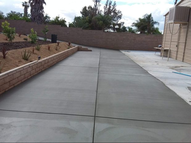 Concrete driveway installation featuring smooth finish and clean lines.