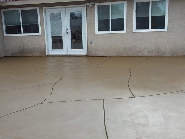 A concrete patio with neatly arranged concrete pavers.
