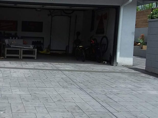 Driveway with concrete patio and garage.